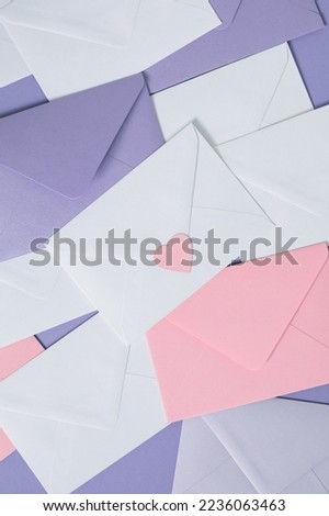 Valentine’s Day background with paper envelopes, pink cut out heart. Marketing, wedding and email newsletter concept.