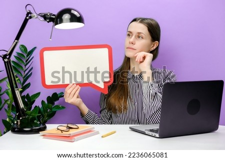 Pensive employee young business woman sitting work at white office desk with laptop empty blank Say cloud speech bubble promotional content prop up chin, posing on purple background wall in studio