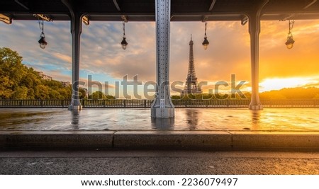  Eiffel Tower and Bir Hakeim Bridge in Paris, France during sunrise.