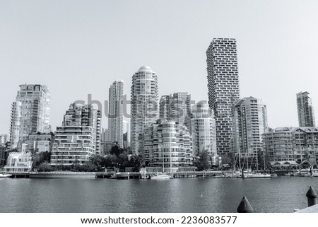 Black and white Vancouver BC cityscape skyline waterfront viewed from Granville Island. Modern buildings architecture 