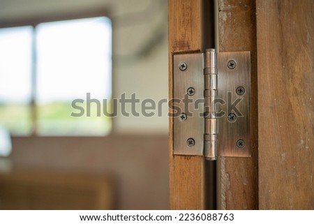 Hinge door wood instll use screwdriver by carpenter Royalty-Free Stock Photo #2236088763