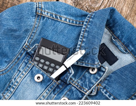 student calculator and pen in jeans jacket pocket