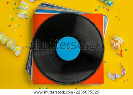 Vinyl records, party music, top view. Empty copy space for record label mockup. Vintage retro sound recording style. Background for the design of a poster, postcard, and flyer for music events. Royalty-Free Stock Photo #2236095525