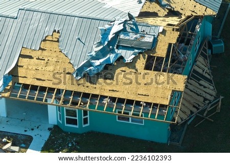 Hurricane Ian destroyed house in Florida residential area. Natural disaster and its consequences Royalty-Free Stock Photo #2236102393