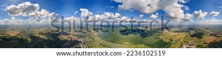 Aerial view from high altitude of earth covered with white puffy cumulus clouds on sunny day Royalty-Free Stock Photo #2236102519