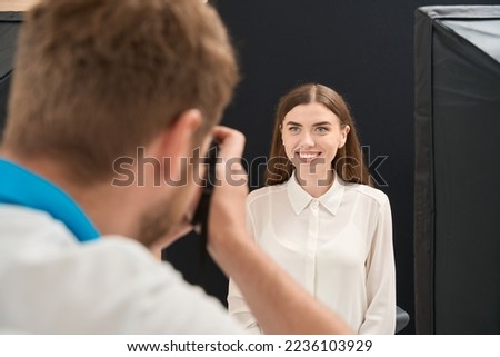 Dental practitioner taking extraoral photos of client teeth