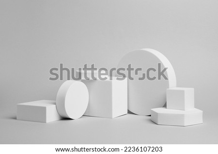 Scene for product presentation. Podiums of different geometric shapes on light grey background