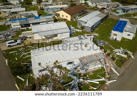 Severely damaged houses after hurricane Ian in Florida mobile home residential area. Consequences of natural disaster Royalty-Free Stock Photo #2236111789