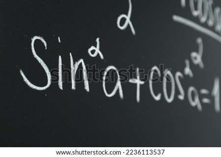Math formula written on chalkboard, closeup view