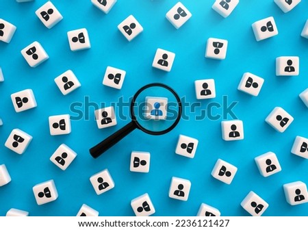 Magnifying glass and highlighted person. Select and recruit. HR search for new employees for the job position. Human resources and the labor market. Identification. Search for a donor. Royalty-Free Stock Photo #2236121427