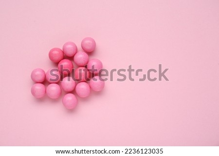 Many bright chewy gumballs on pink background, flat lay. Space for text Royalty-Free Stock Photo #2236123035