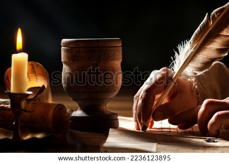 Mystical medieval hands writing with quill pen Royalty-Free Stock Photo #2236123895