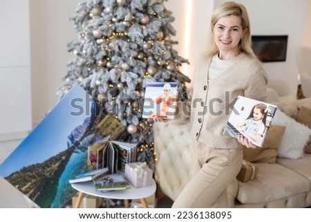 woman holding a photo canvas as a Christmas present
