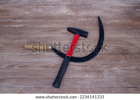 Image of a hammer and sickle on wooden background. World symbol.
