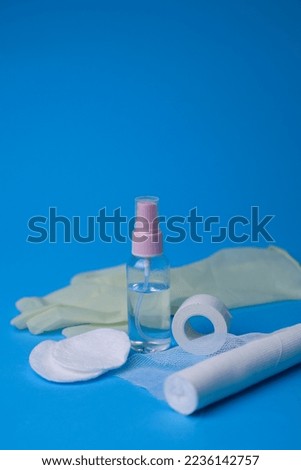 medical items plaster bandage sanitizer sponge cotton wool medical sterile gloves on a blue background. for labels, signs, flyers, store signs, etc.