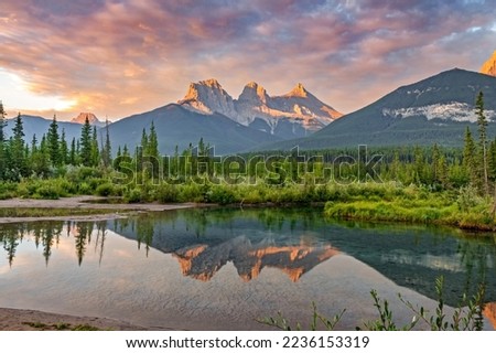 Iconic Canmore Alberta photograph. Three Sisters in the Canadian Rocky Mountains, Banff National Park Royalty-Free Stock Photo #2236153319
