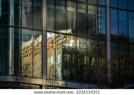Abstract view of modern office buildings reflected in the windows of another modern office building
