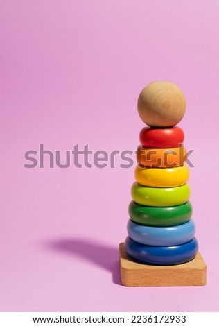 Kids multicolored toy on purple background