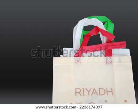 top view of few shopping bags isolated on black background. Fabric material non woven bags. Package collection reusable tote eco bags.