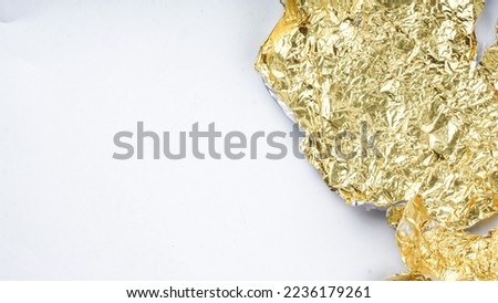 Blur Texture of the gold leaf. Yellow wallpaper. Wrinkled foil texture with reflections background.
