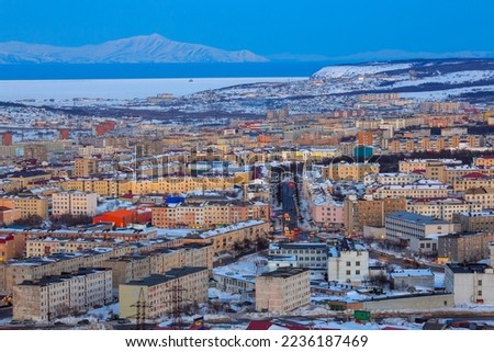 Aerial cityscape view of Magadan. Portovaya street and the arch with the text in Russian "City Park". Beautiful evening landscape with many buildings. City of Magadan, Magadan Region, Fare East Russia Royalty-Free Stock Photo #2236187469