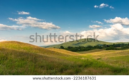 Rolling hills with clouds in the finger lakes of western New York Royalty-Free Stock Photo #2236187631