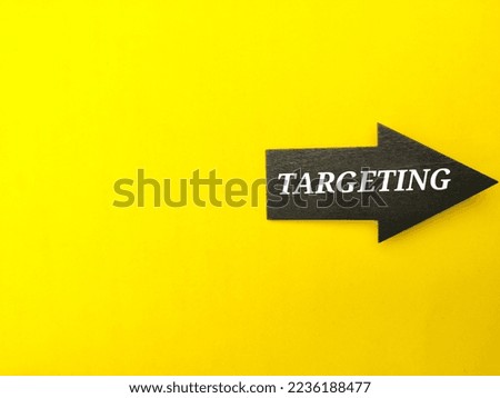 Arrow wooden board with the word TARGETING on a yellow background.
