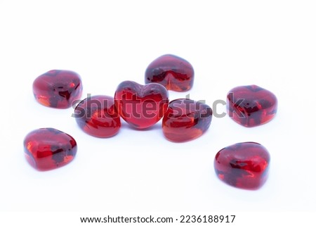 Red glass hearts on white background.