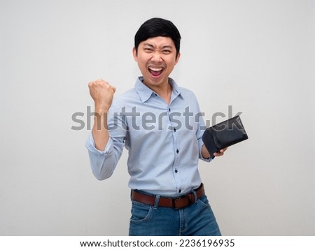 Asian businessman holding wallet feels satisfied happy show fist up about rich isolated Royalty-Free Stock Photo #2236196935