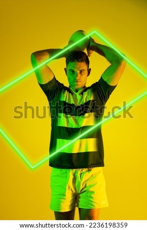 Illuminated green rectangle over caucasian male rugby player throwing ball on yellow background. Copy space, composite, sport, shape, competition, playing, match and abstract concept.