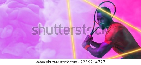 Illuminated triangle over african american male player playing tennis over purple smoky background. Racket, copy space, composite, sport, competition, shape, playing, match and abstract concept.