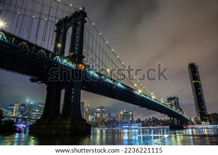 Manhattan Bridge and panoramic night view of downtown Manhattan after sunset in New York City, USA