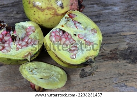 Fresh pomegranate close up picture on the wooden background. Healthful natural fruits for cancer patient
