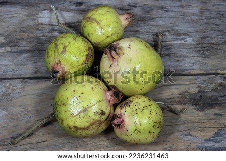 Fresh pomegranate close up picture on the wooden background. Healthful natural fruits for cancer patient
