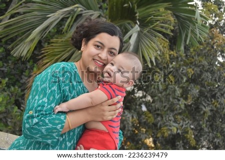 Happy smiling Beautiful Indian ethnic woman mother hugging her little child boy. Healthcare and medical love Asia woman lifestyle mother's day concept . Indian mom and baby outdoor mage.