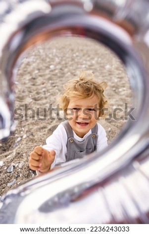 A boy with a balloon with number 2 on his birthday on the beach. High quality photo
