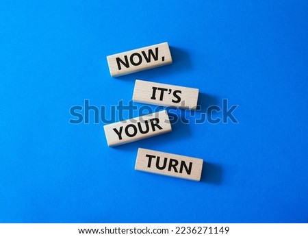 Now it's your turn symbol. Concept words Now it's your turn on wooden blocks. Beautiful blue background. Business and Now it's your turn me concept. Copy space Royalty-Free Stock Photo #2236271149