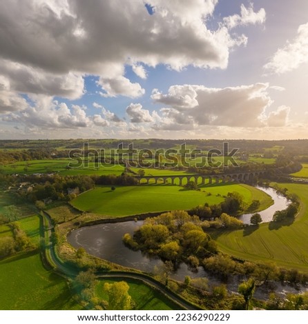 Aerial view over Arthington Viaduct and the River Wharfe on a sunny autumn day. Meandering river bends through the North Yorkshire countryside. UK Royalty-Free Stock Photo #2236290229