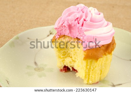 Image of cup cake in ceramic dish on brown sack
