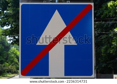 One way street road sign, White arrow in blue background, crossed out of red line on autumn foliage background. Now movement two way in city street.Concept of road sign,selective focus with copy space
