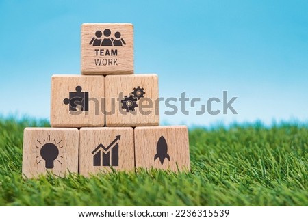 Business teamwork concept icons on wooden cube blocks. Ethical business culture. Investment and sustainable development. Business and moral integrity.