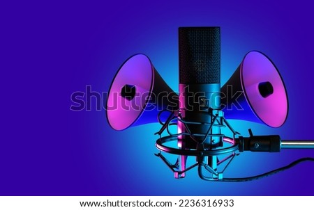 Microphone and loudspeaker. Audio equipment. Amplification of persons voice. Recording devices and voice amplification. Professional microphone on purple. Radio microphone on horizontal stand Royalty-Free Stock Photo #2236316933