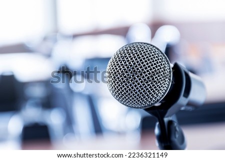 Close up microphone with tripod on stage in seminar room.
