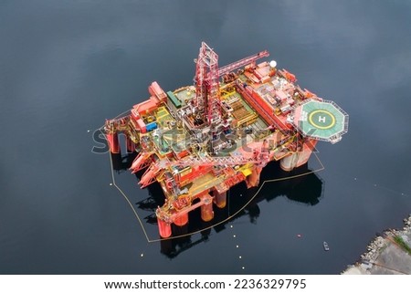 Aerial view of an offshore oil drilling platform and maintenance dock in a fjord in Norway Royalty-Free Stock Photo #2236329795