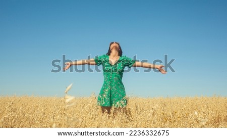 The beauty of the woman in nature with open arms and breathing the fresh air. an invitation to live life to the fullest, to enjoy the freedom of being outdoors. Life is to enjoy and let yourself go Royalty-Free Stock Photo #2236332675