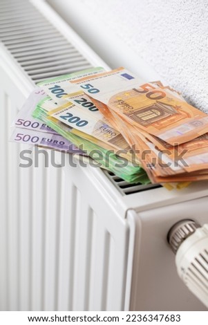 Euro banknotes heating radiator, concept for rising energy prices and inflation.
