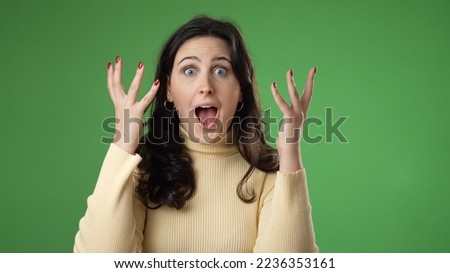 Portrait of excited, surprised smiling pretty young hipster woman 20s smiling isolated on green screen background studio