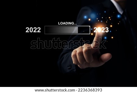 Businessman pointing to 2023, loading bar for count down from 2022 to 2023 year, Start up business and success. Royalty-Free Stock Photo #2236368393