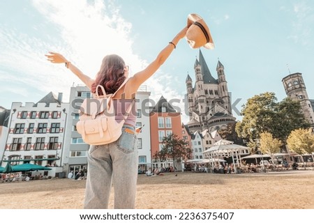 Happy tourist girl walks and enjoys vacations in the old town of Cologne at fish market square. Germany travel and sightseeing Royalty-Free Stock Photo #2236375407