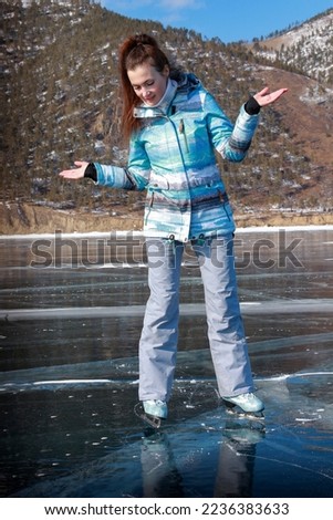 A girl skates on ice in winter